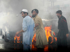 Pakistani security personnel gather by t Pakistani security personnel gather by t